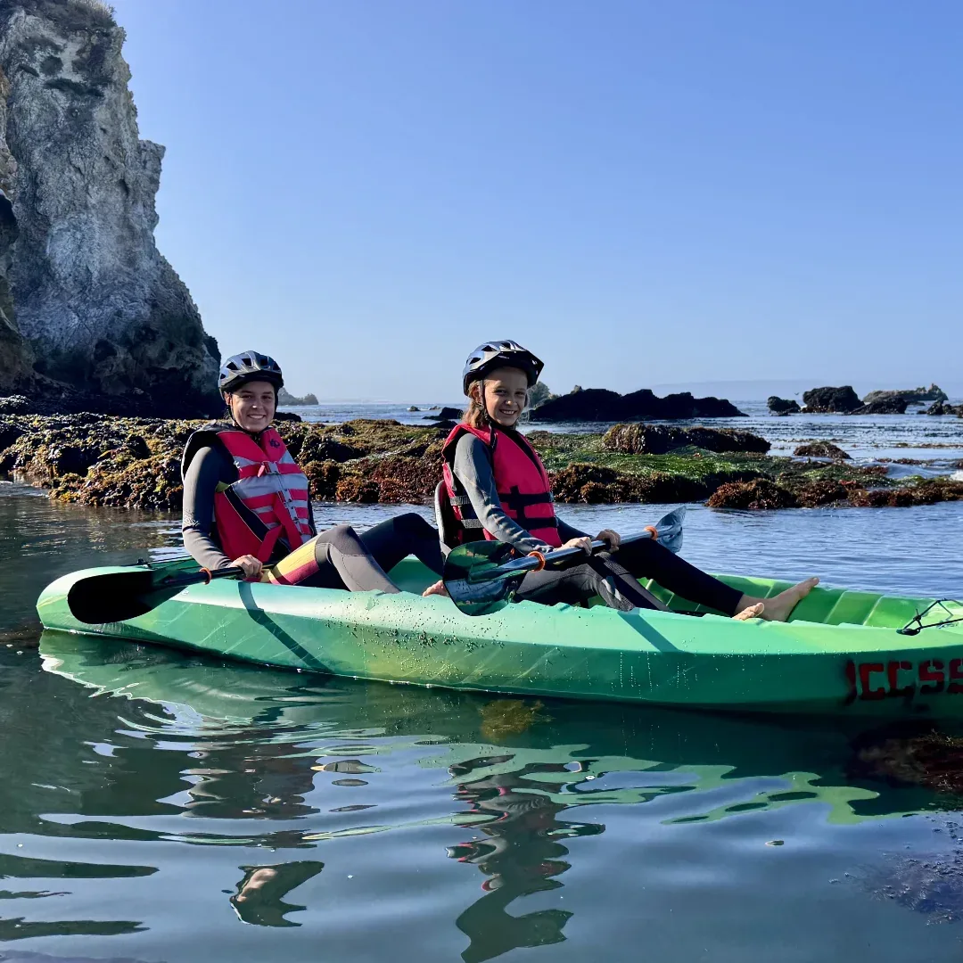 Family paddling the calm Avila Beach estuary